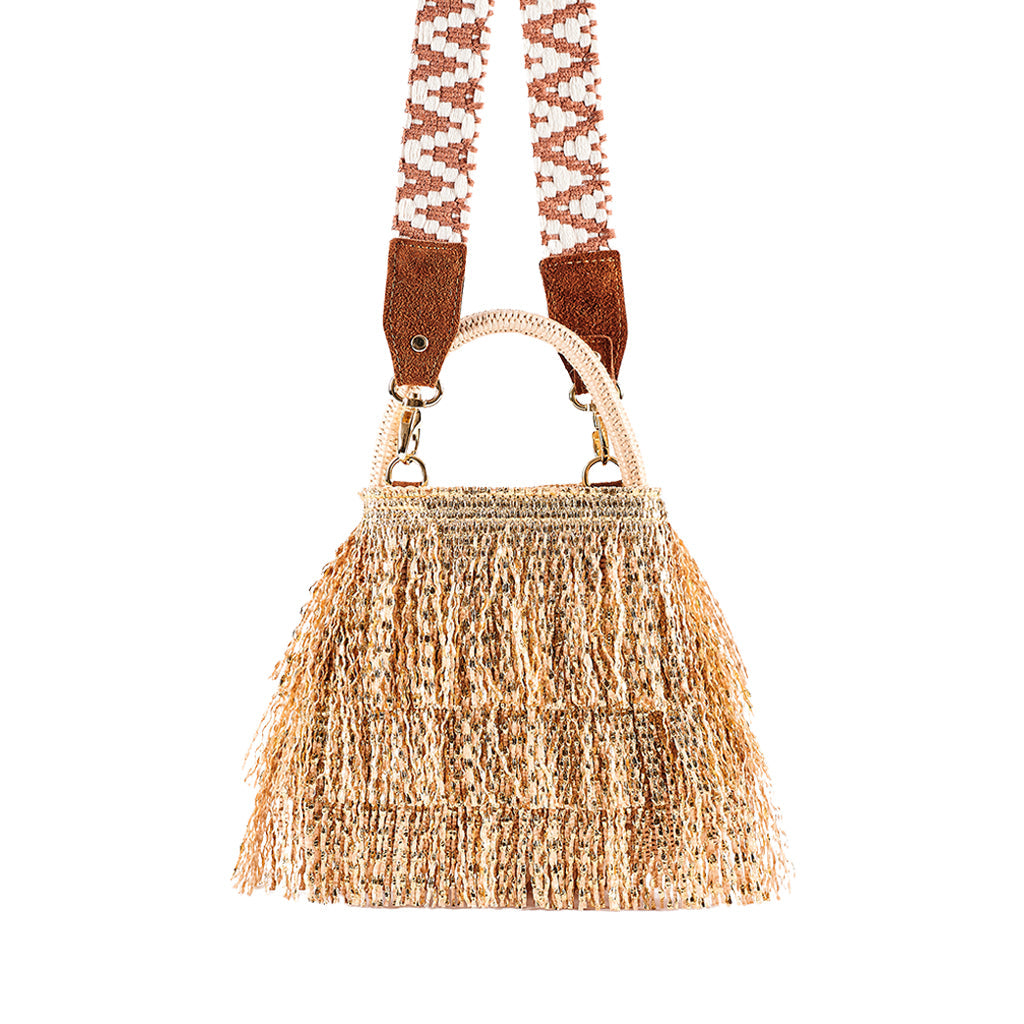 Woven fringe handbag with decorative shoulder strap against white background