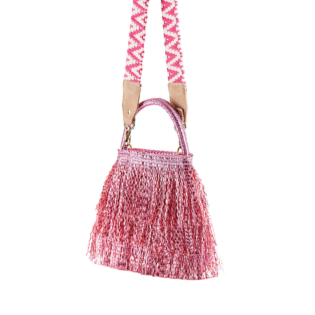 Pink woven fringe handbag with patterned shoulder strap