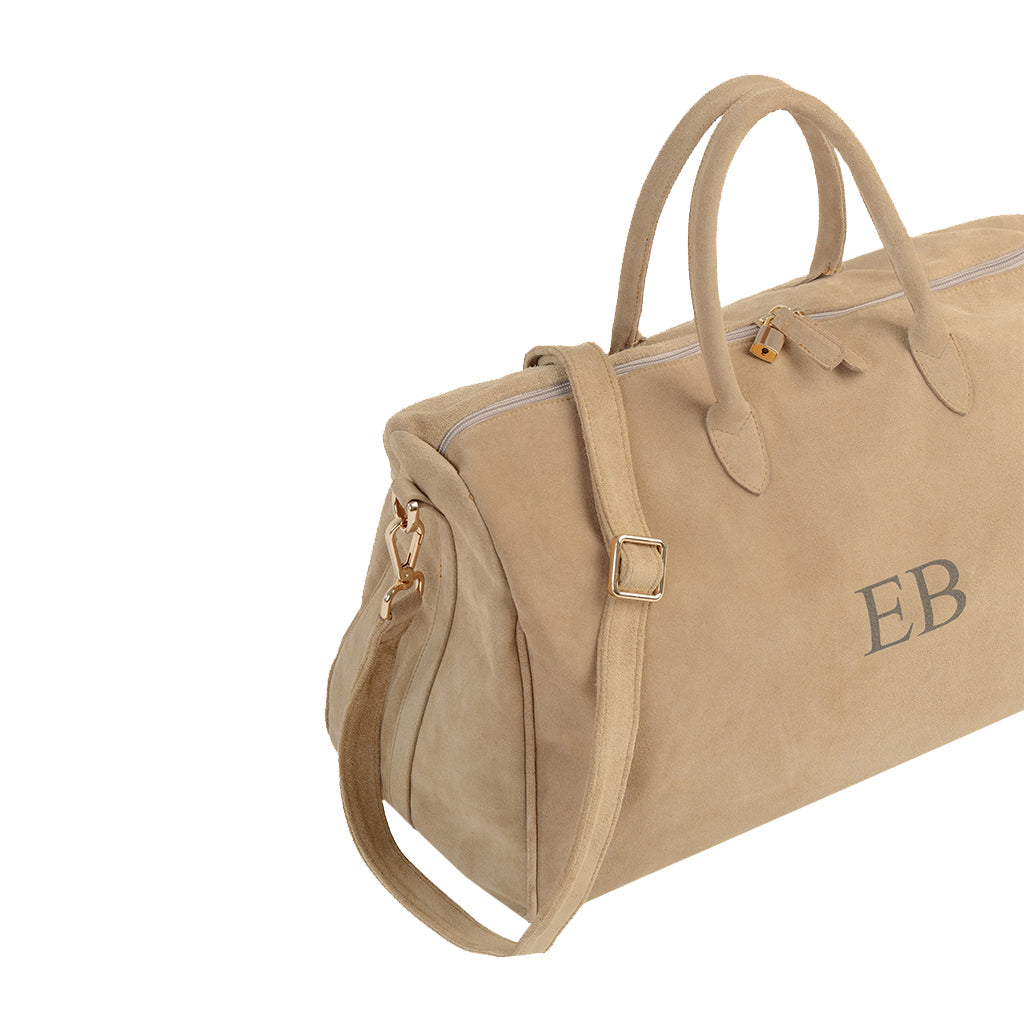 Tan suede duffle bag with gold hardware and monogram initials EB