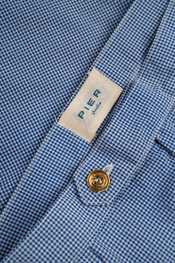 Close-up of blue checkered dress shirt with Pier Italia label and gold button