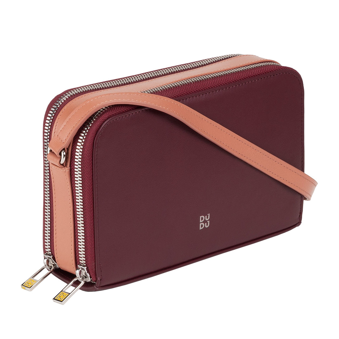 Burgundy leather crossbody bag with beige strap and dual zipper compartments
