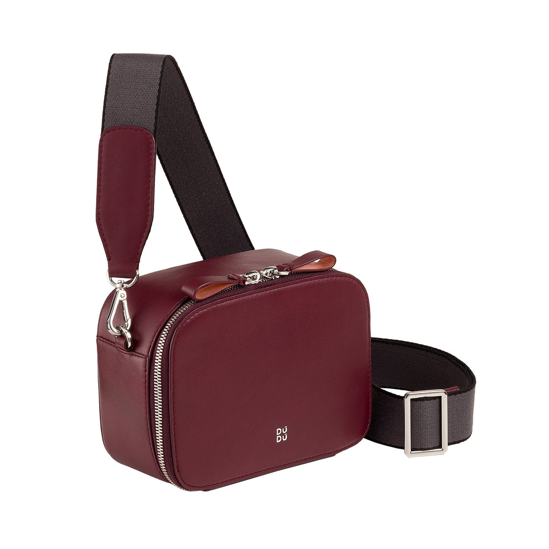 Maroon leather crossbody bag with adjustable black strap and silver zipper