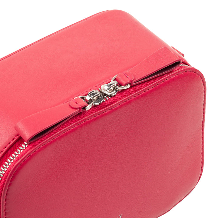 Close-up of a red leather handbag with a silver zipper and bow detail