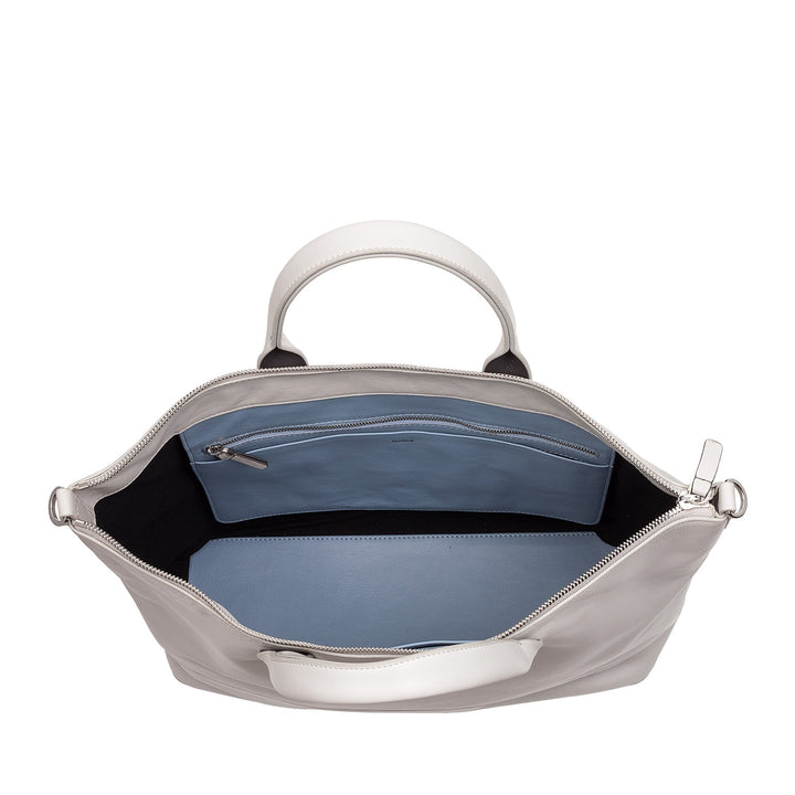 Inside view of an open white leather handbag with blue interior lining and a zippered pocket