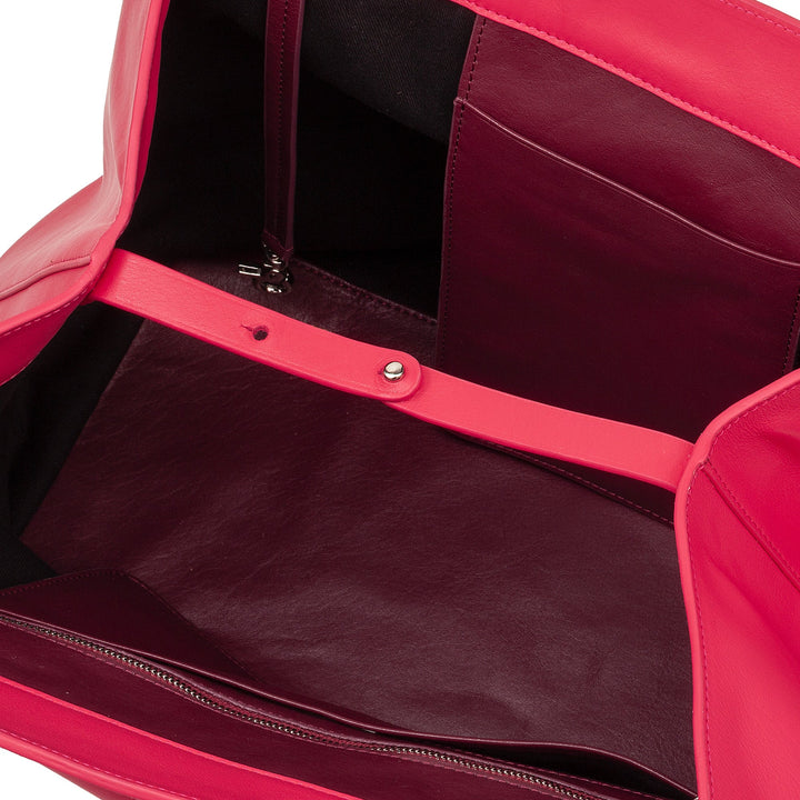 Close-up of open pink leather tote bag showing interior compartments and pockets
