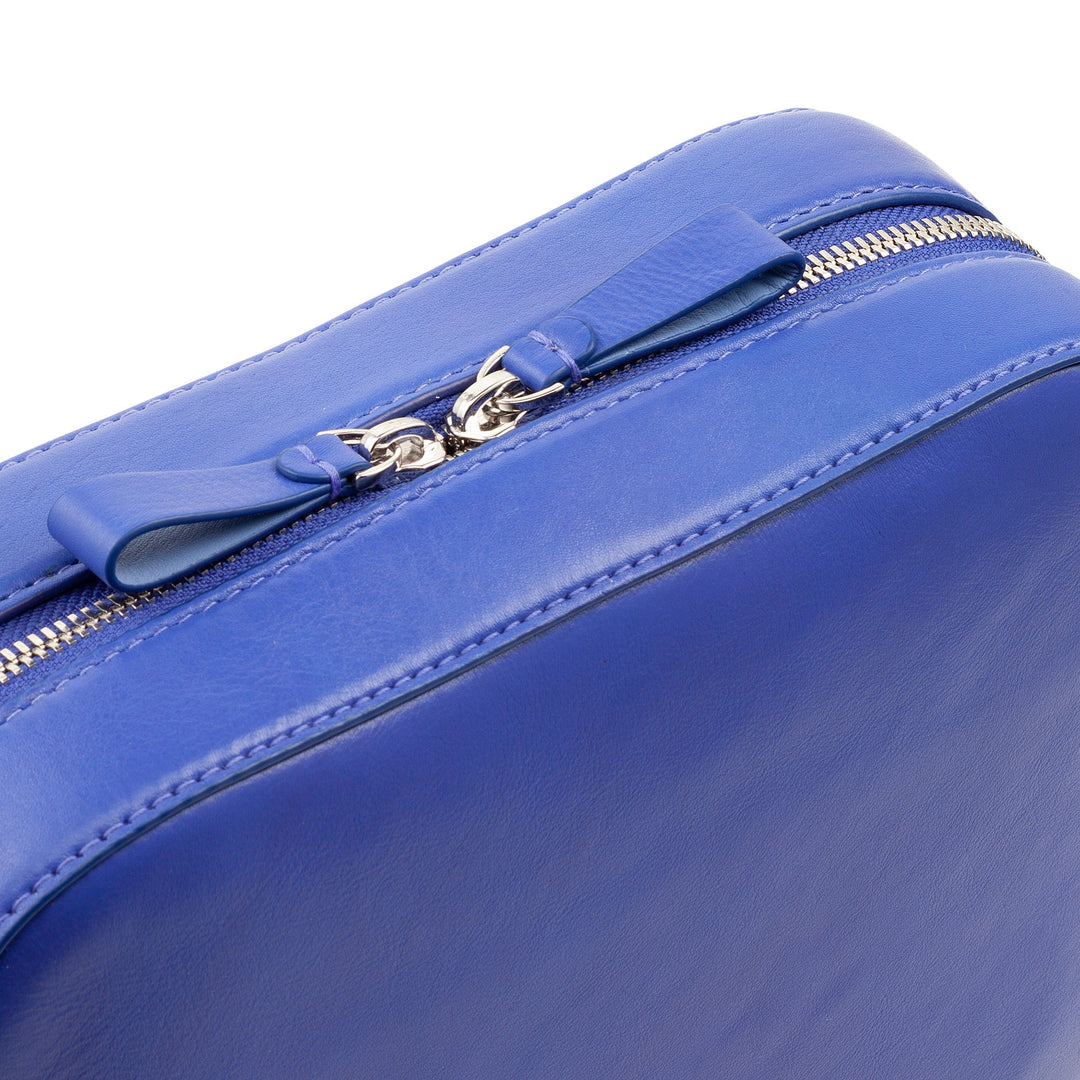 Close-up of a royal blue leather zipper pouch with detailed stitching