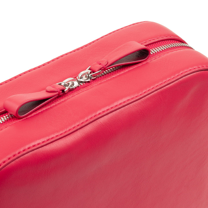 Close-up of a red leather handbag with zipper details