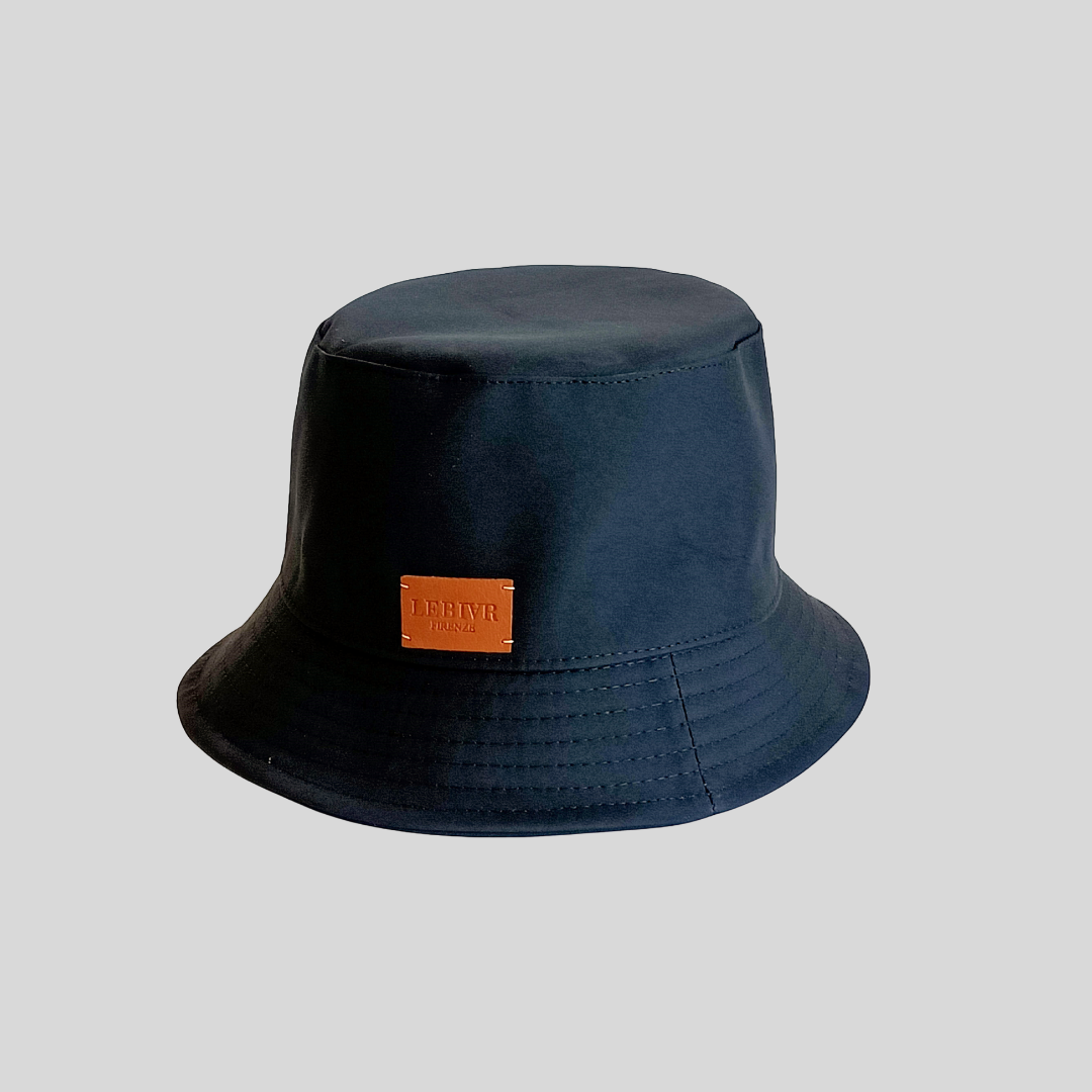 Dark blue bucket hat with leather patch on front