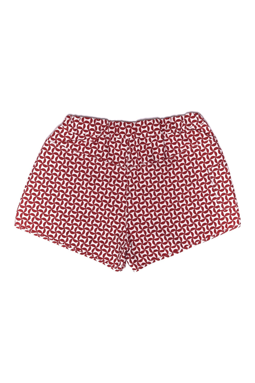 Red and white geometric patterned shorts on a white background