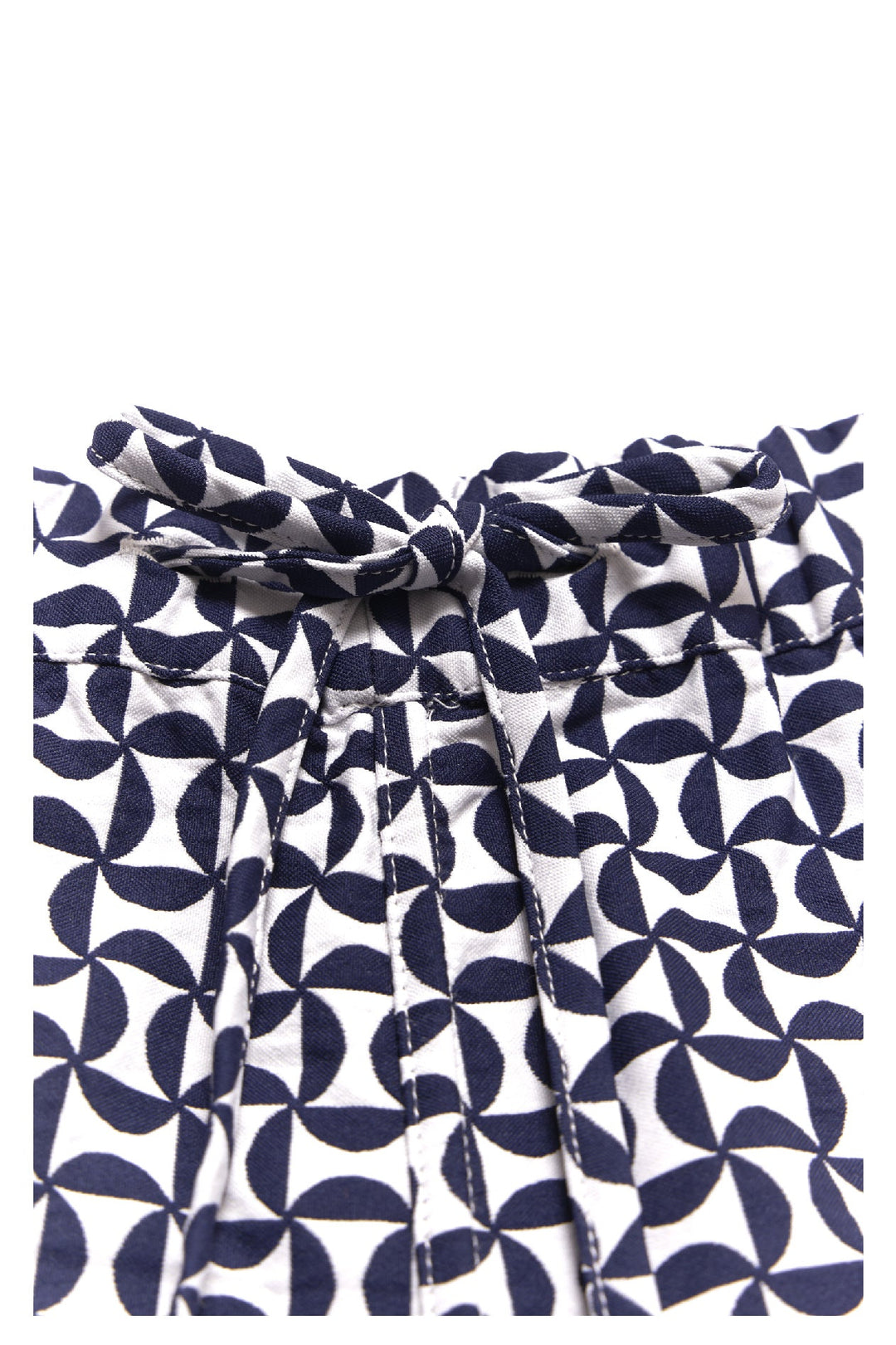 Close-up of navy and white geometric patterned fabric with a bow