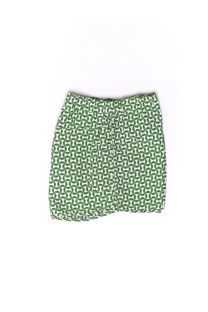 Green and white geometric patterned skirt against white background