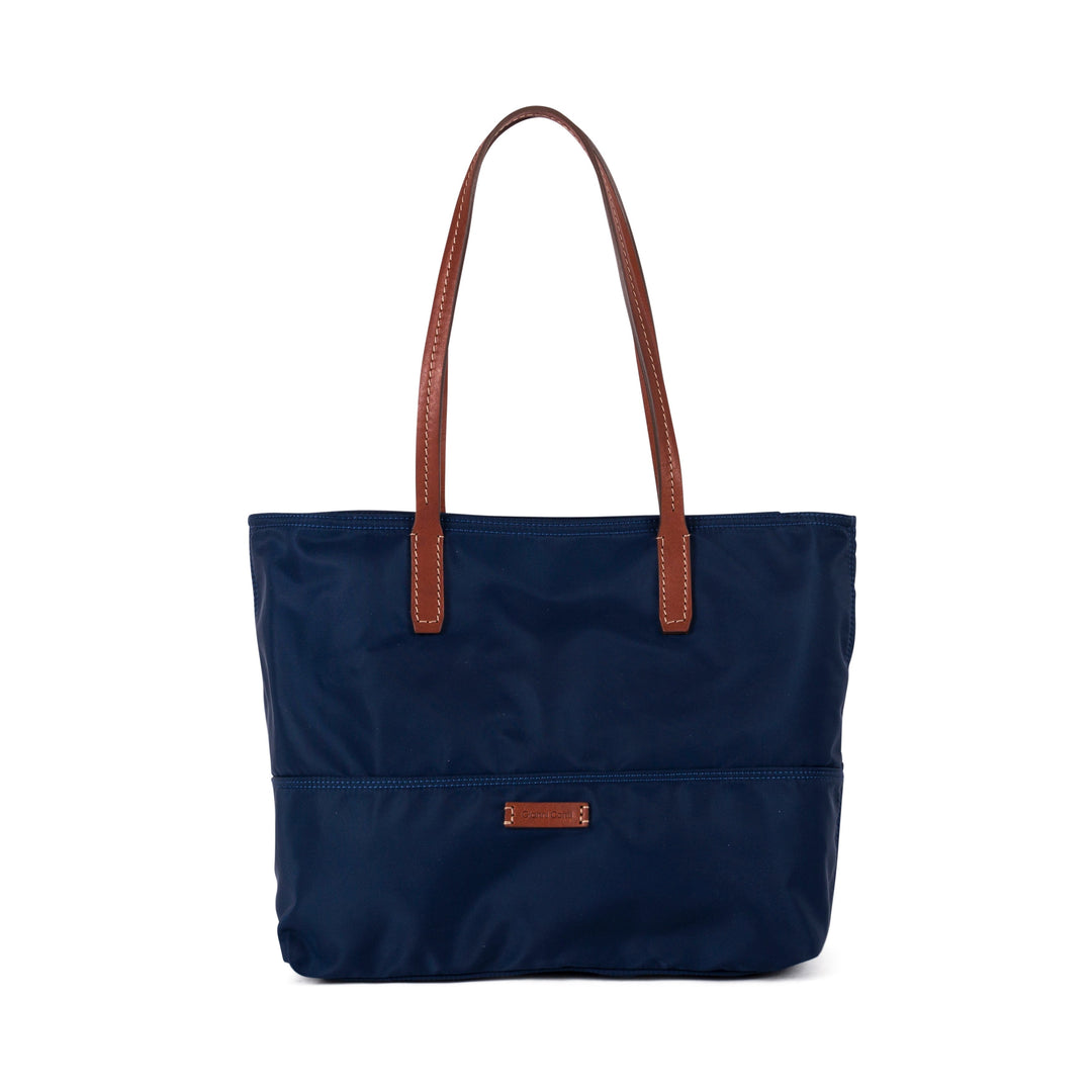 Stylish navy blue tote bag with brown leather handles