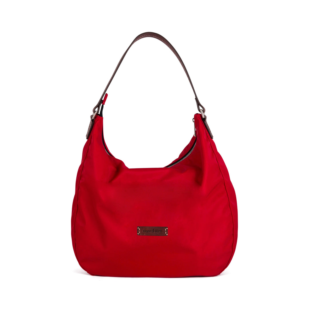 Red shoulder bag with dark brown strap and logo plaque