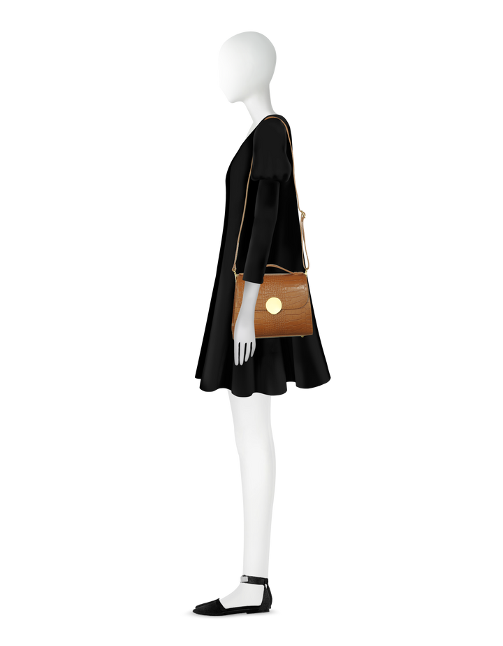 Side view of mannequin with black dress, brown crossbody bag, and black flats