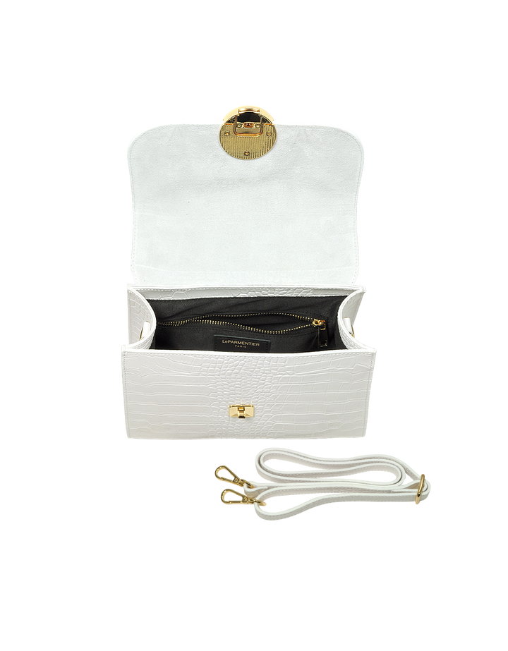 White leather crossbody handbag with open flap displaying interior compartments and detachable strap