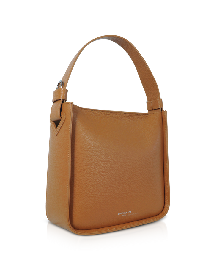 Tan leather handbag with sturdy handle on white background