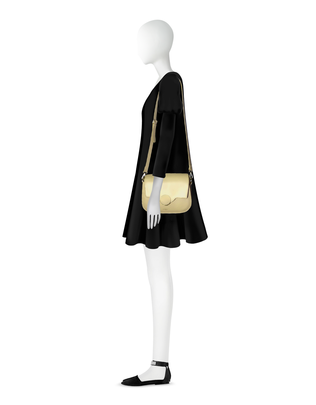 Side view of mannequin wearing a black dress and cream shoulder bag