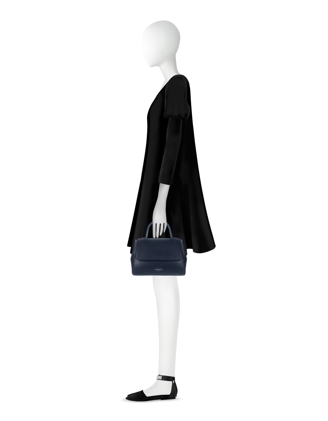 Fashion mannequin in black dress holding navy blue handbag