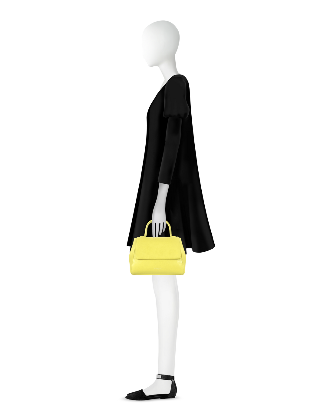 Model wearing a black dress and holding a yellow handbag