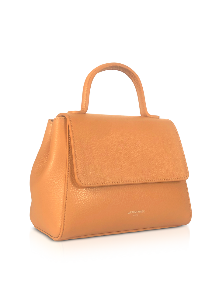 Tan leather handbag with top handle on reflective surface