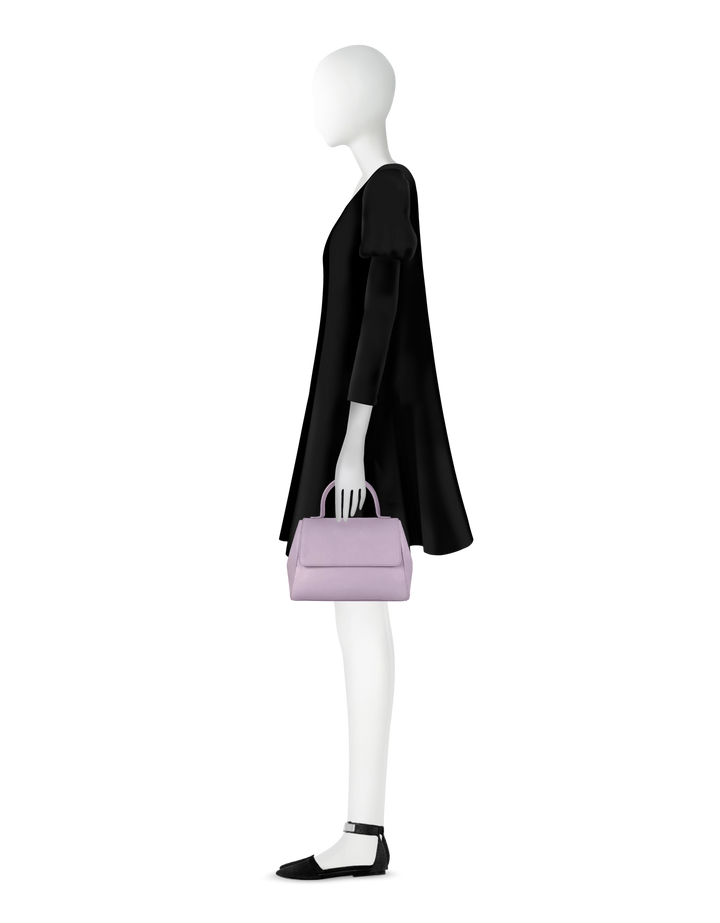 Side view of mannequin in black dress holding a light purple handbag