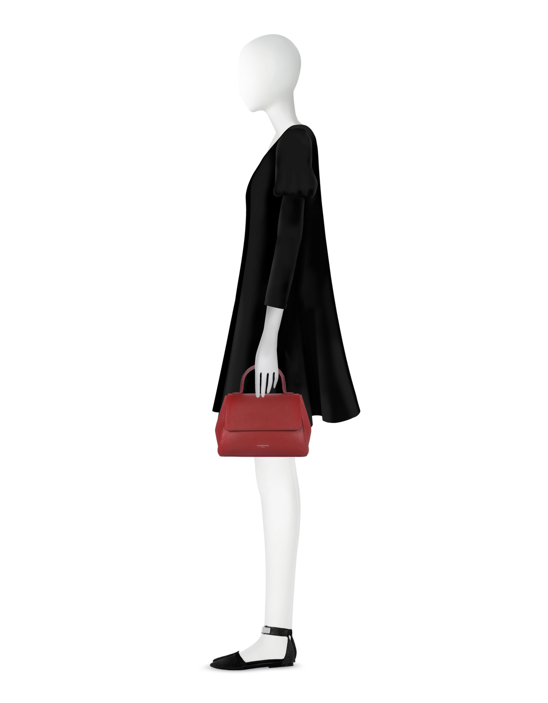 Side view of a mannequin in a black dress holding a red handbag