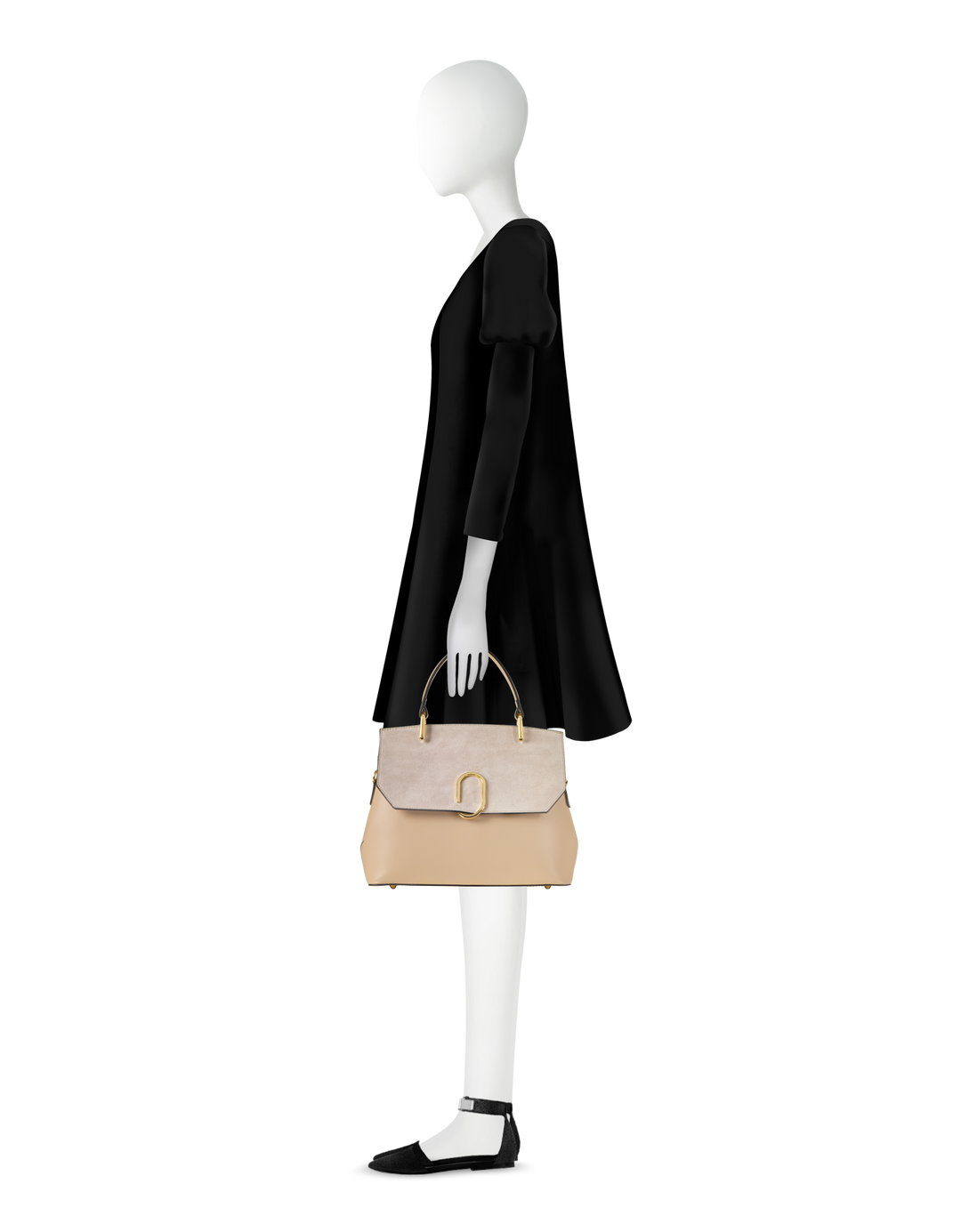 Side view of mannequin holding tan leather handbag while wearing black dress and black shoes