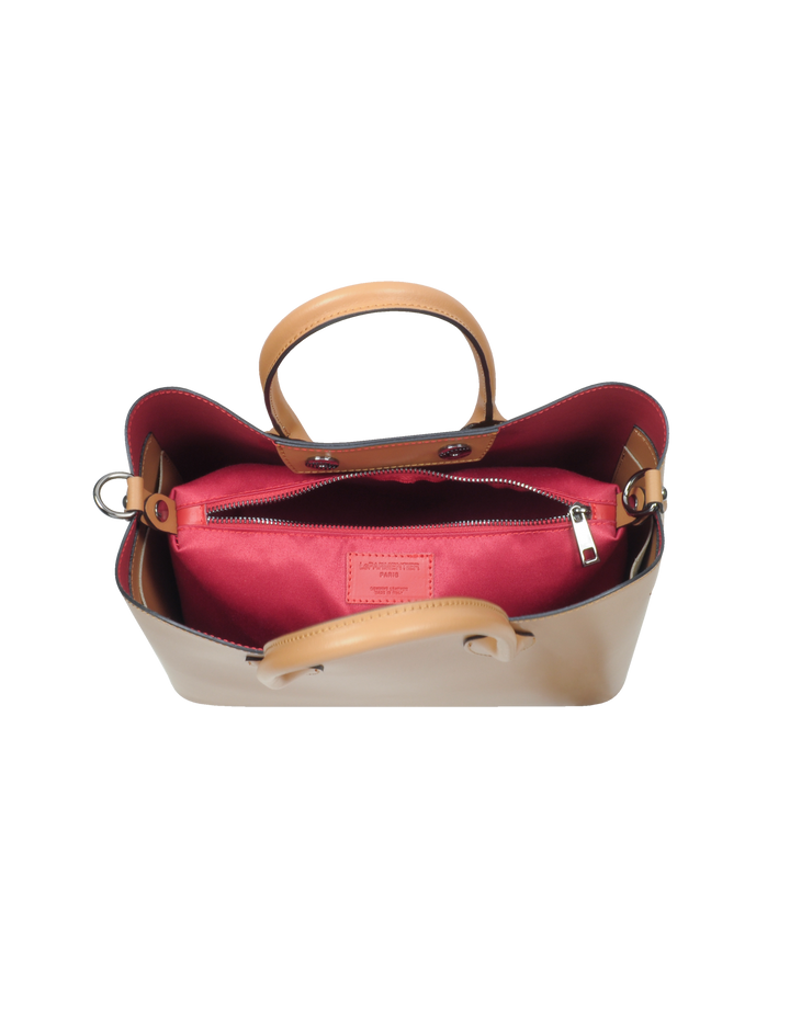 Open tan leather handbag with red interior and handle, displaying a zippered pocket