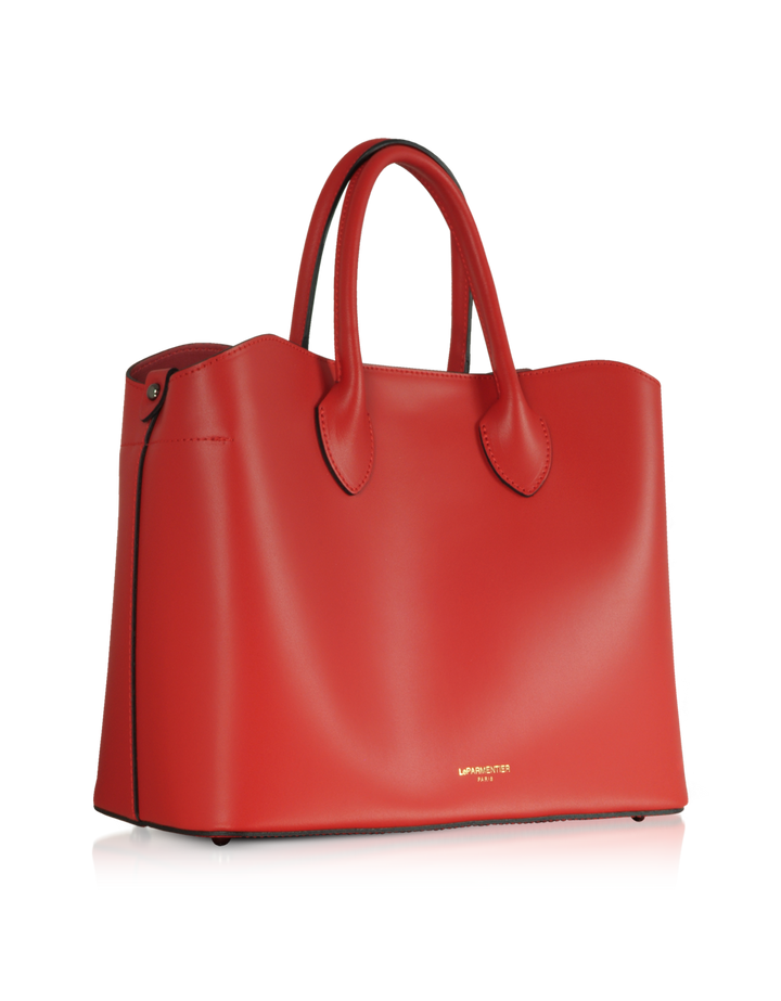 Red leather designer handbag with handles on reflective surface