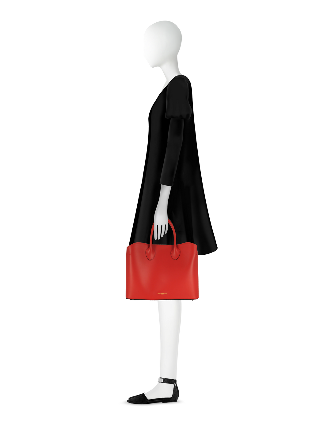 Side view of a mannequin wearing a black dress, holding a red handbag