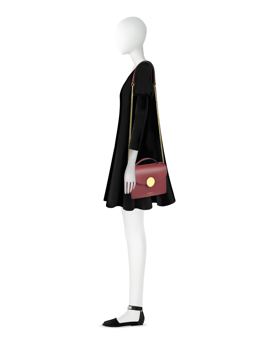 Mannequin in black dress with red handbag and black shoes