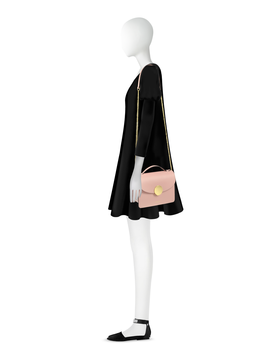 Stylish mannequin in a black dress holding a pink handbag with gold chain strap