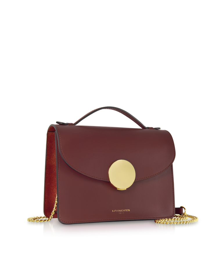 Stylish burgundy leather handbag with gold chain strap and circular clasp