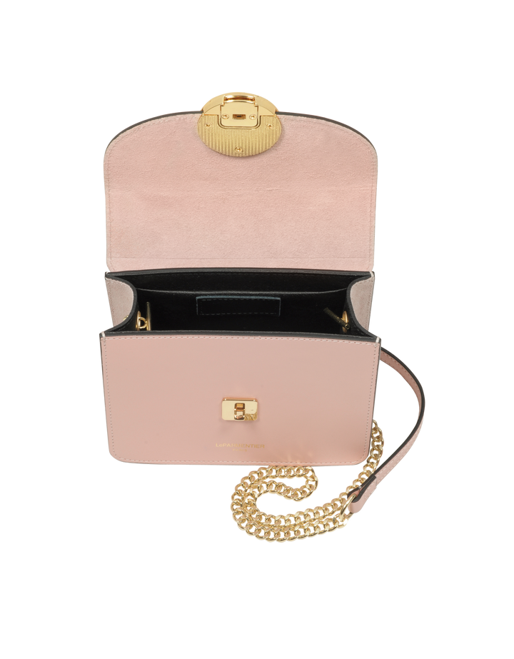 Open luxury pink leather handbag with a gold chain strap and clasp