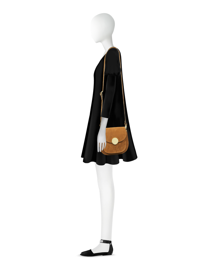 Side view of mannequin with black dress and brown crossbody bag