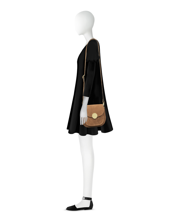 Person modeling black dress and brown crossbody bag