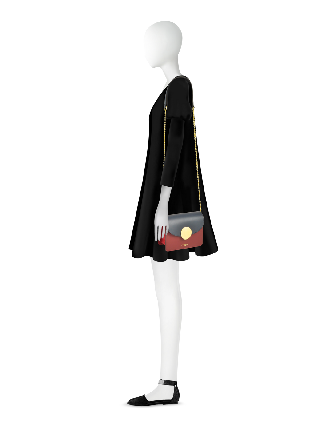 Fashionable mannequin in black dress holding a stylish shoulder bag