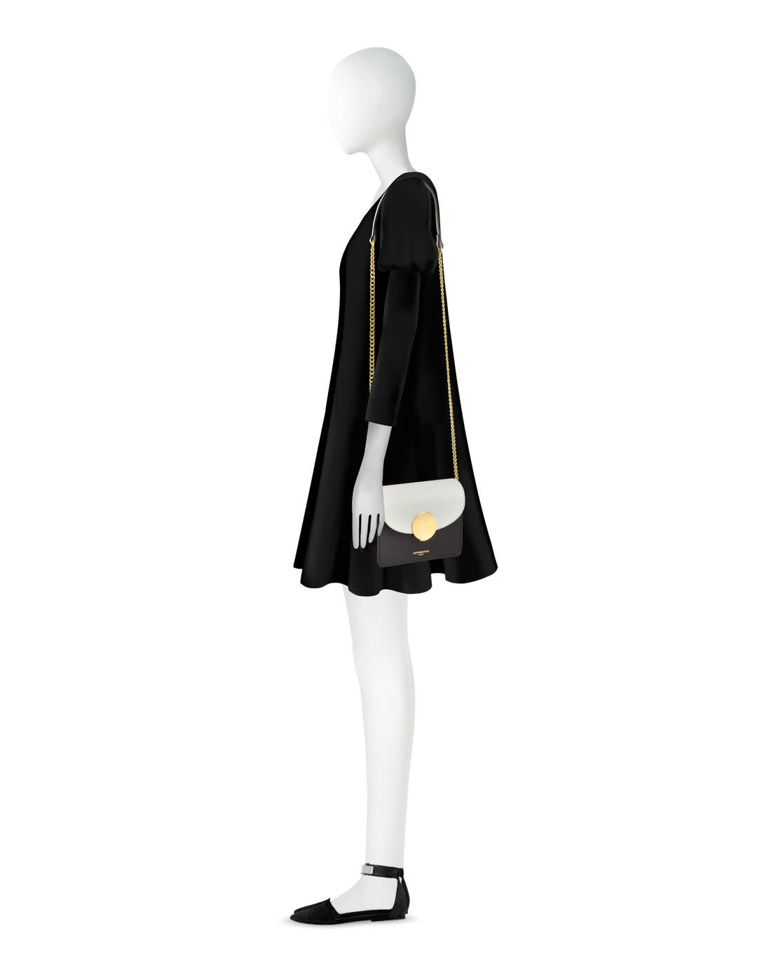 Side view of a mannequin wearing a black dress with a gold chain handbag