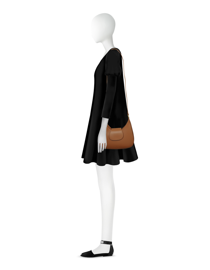 Side view of a mannequin in a black dress with a brown shoulder bag