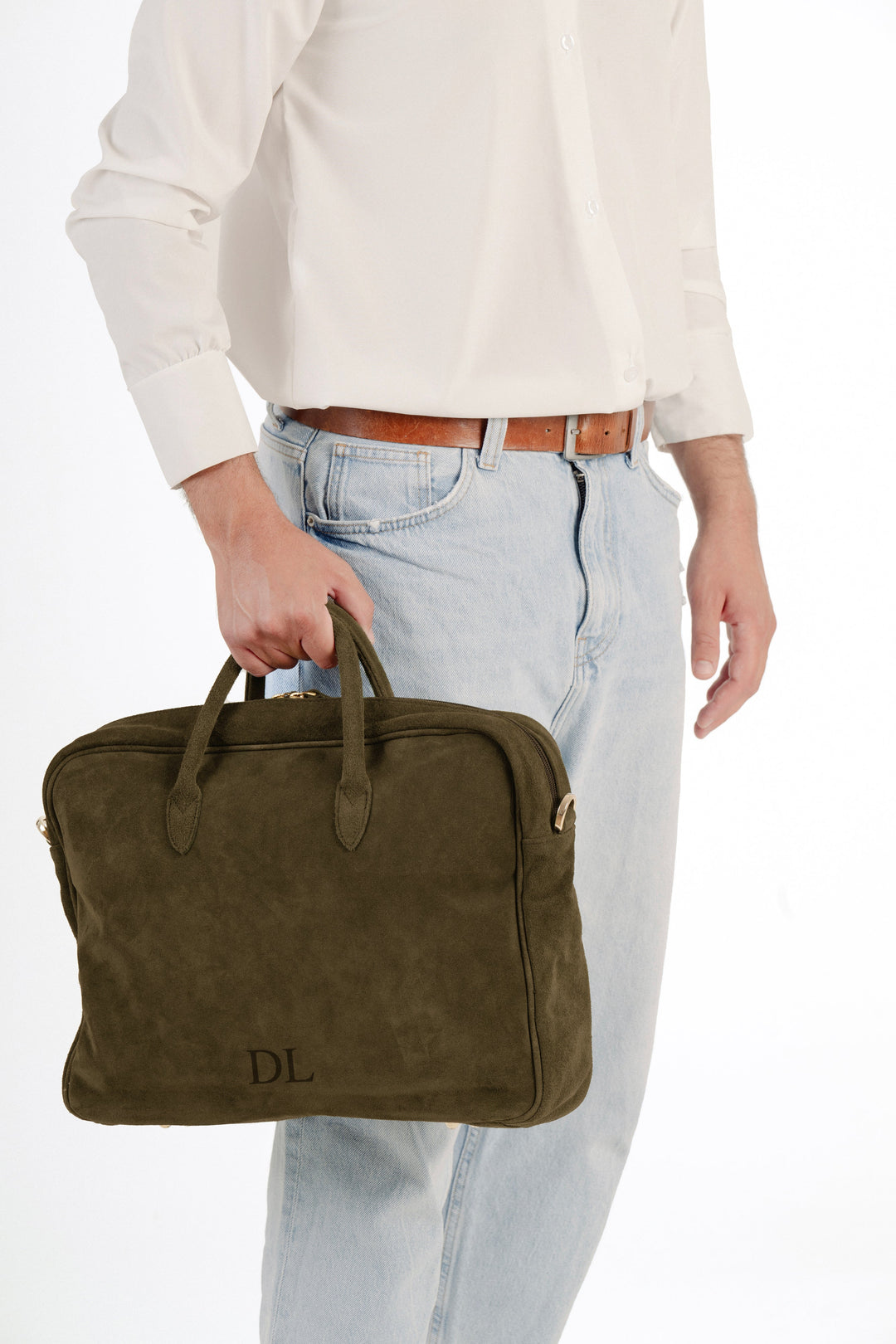 Person holding olive green suede laptop bag with initials DL