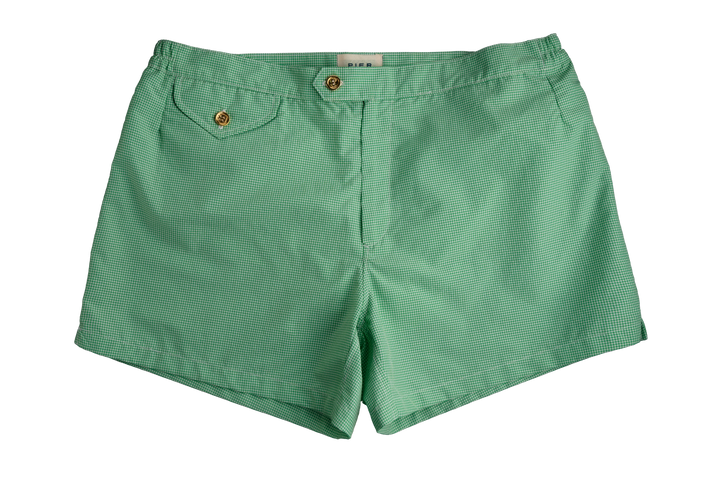 Green men's shorts with buttoned pockets laid flat