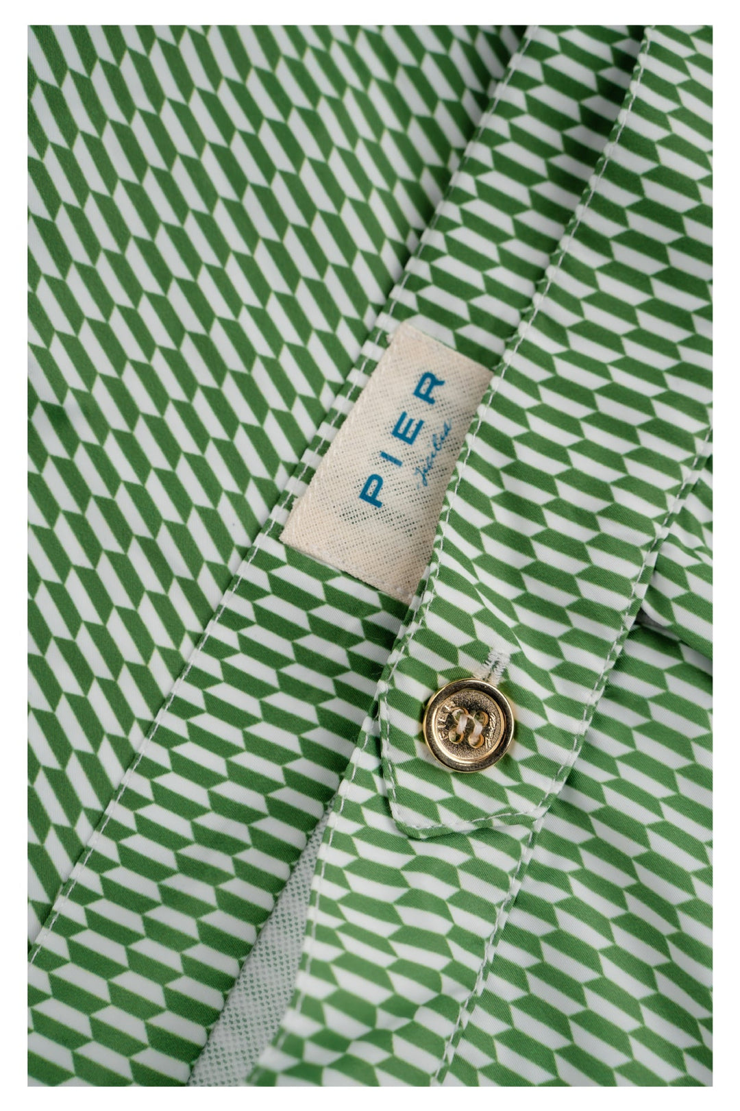 Close-up of green geometric pattern shirt with Pier Lane label