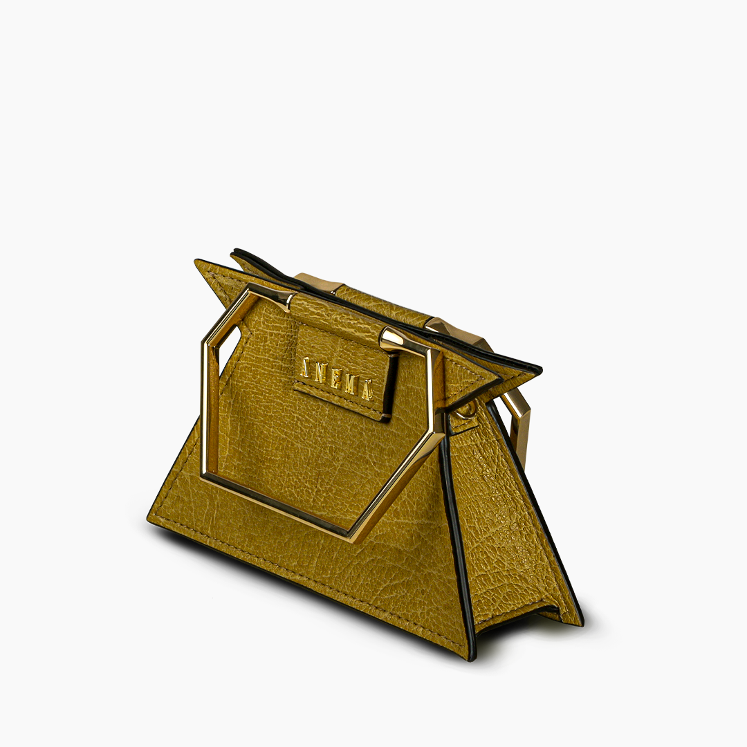 Gold triangular designer handbag with geometric handle