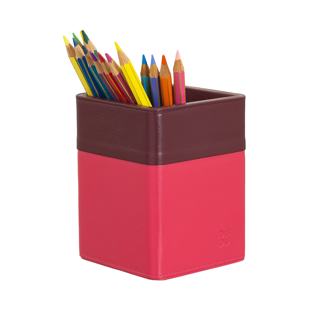 Colorful pencils in a pink and brown leather desk organizer
