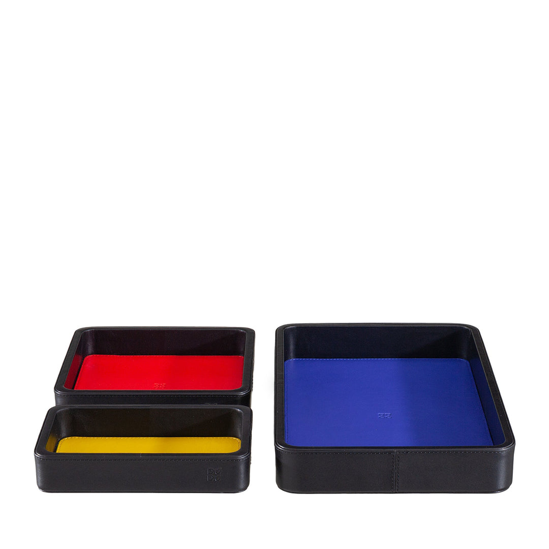 Set of three black leather trays with colorful interiors in blue, red, and yellow