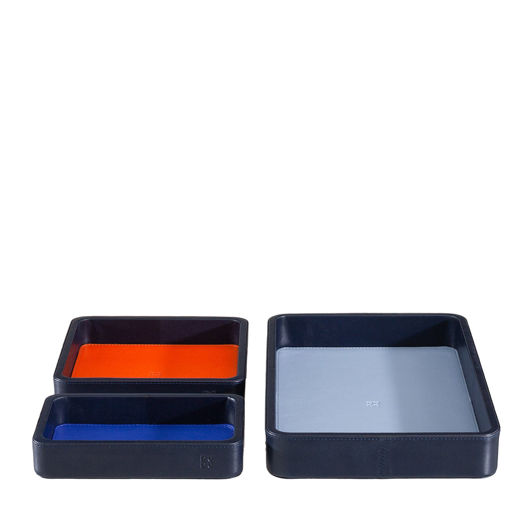 Three black leather trays in varying sizes with colorful interior linings, including orange, blue, and grey