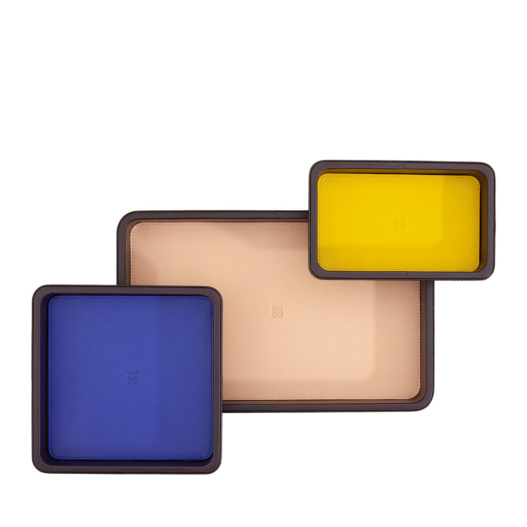 Three colorful rectangular trays of different sizes, including blue, beige, and yellow
