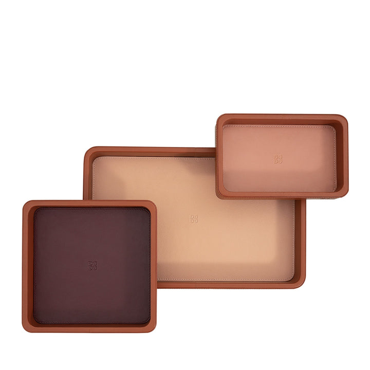 Set of three leather trays in varying sizes with brown, beige, and tan colors