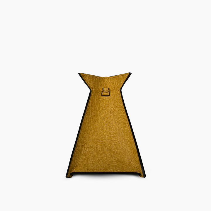 Minimalist yellow leather handbag with unique triangular shape and top handle