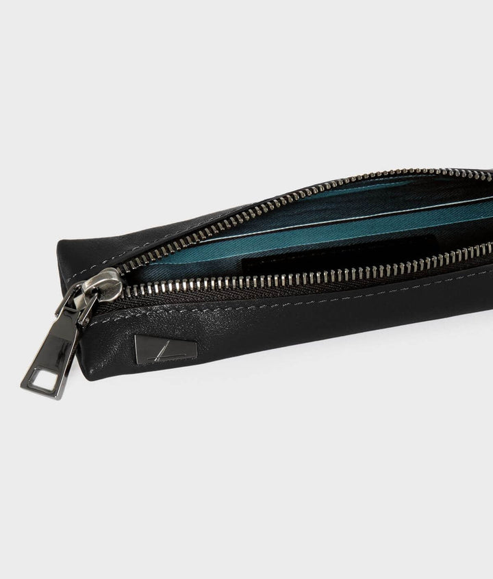 Black leather pencil case with zipper partially open, revealing blue and green striped interior